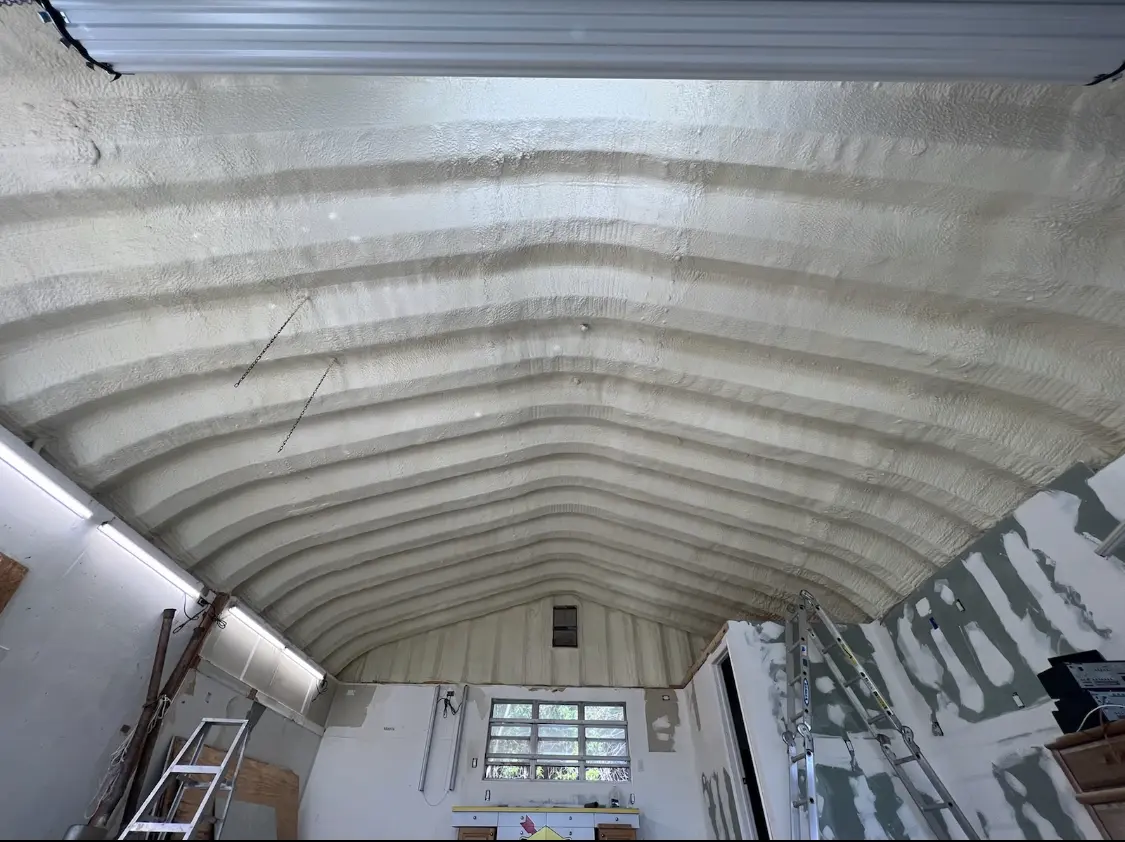Spray polyurethane foam applied to the underside of a metal roof deck in Laurel